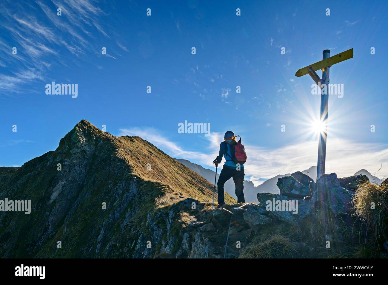 Austria, Tyrol, Female hiker following Aschaffenburger Hohenweg trail ...