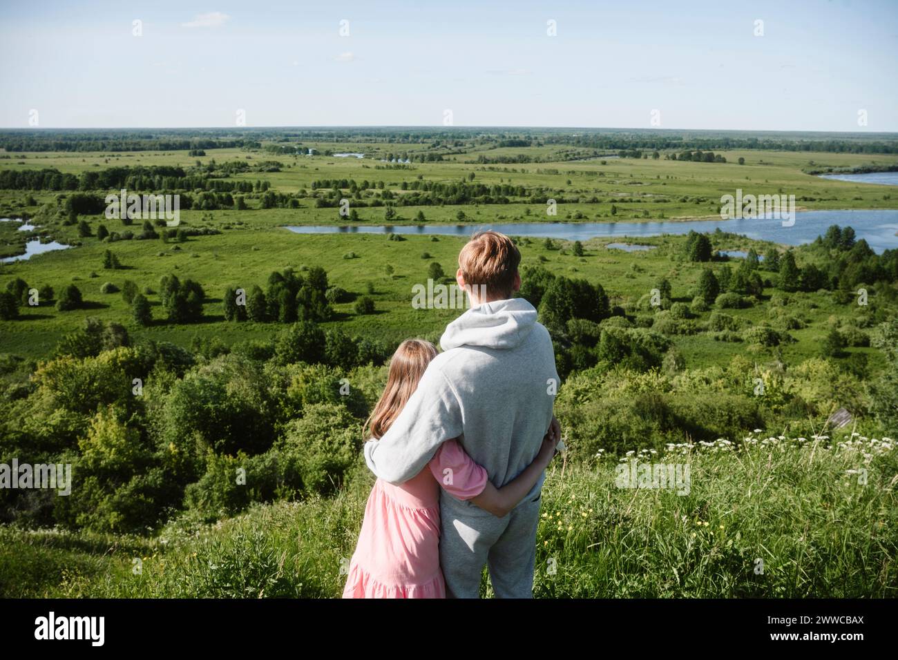 Father and daughter embracing and looking at grass area Stock Photo - Alamy