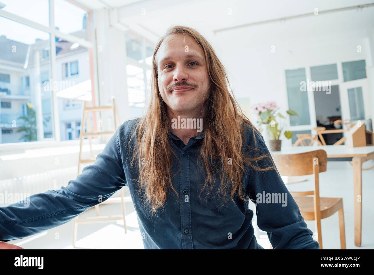 Man long hair sits hi-res stock photography and images - Alamy