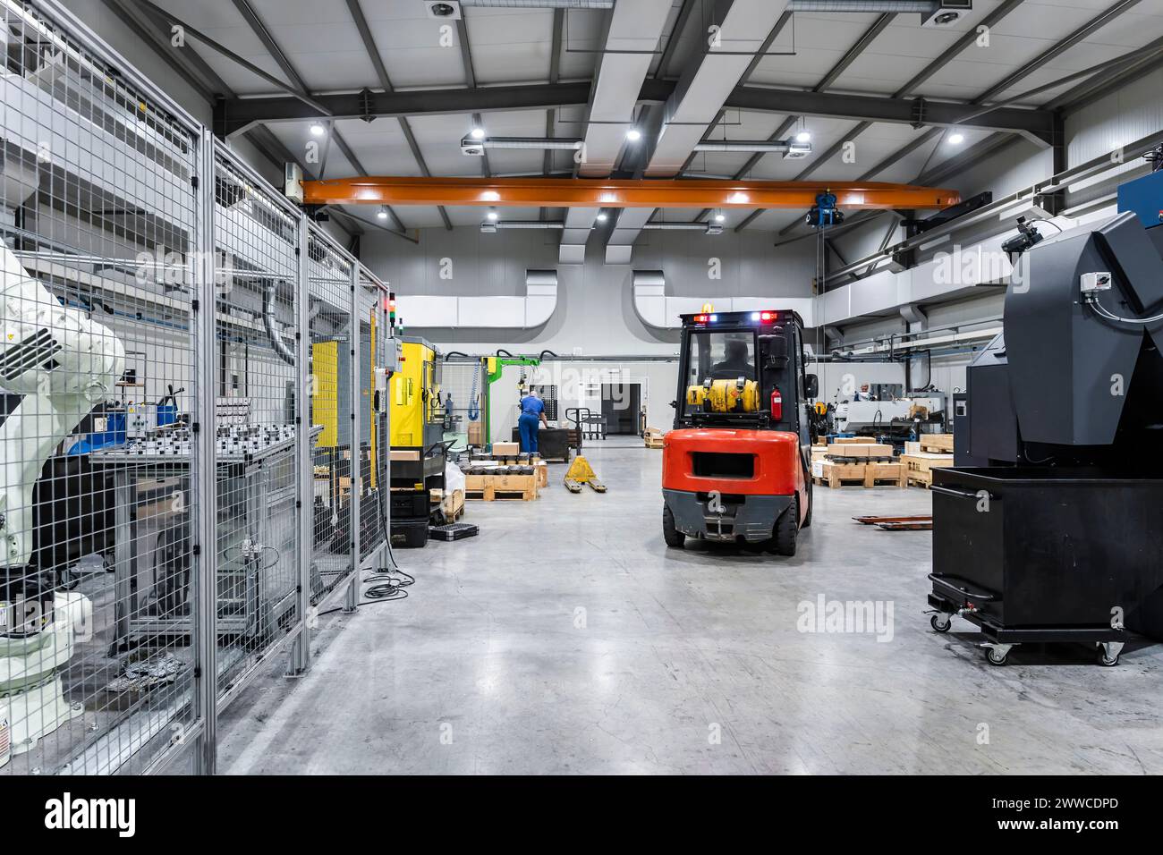Forklift in illuminated modern factory Stock Photo
