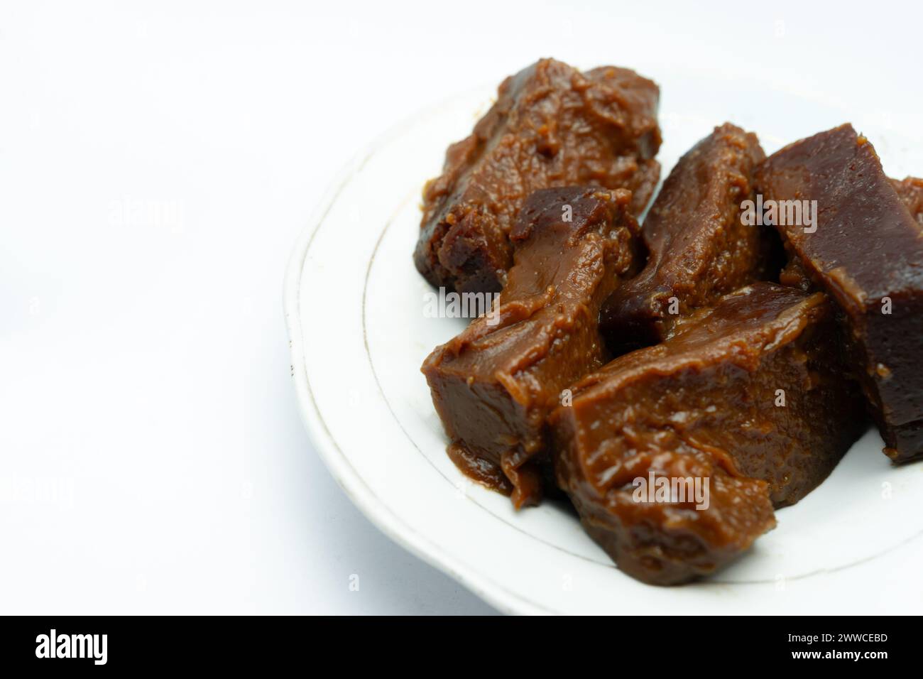 Dodol on a serving plate. This traditional sweet snack originating from Indonesia made from glutinous rice flour, coconut milk and brown sugar that ar Stock Photo