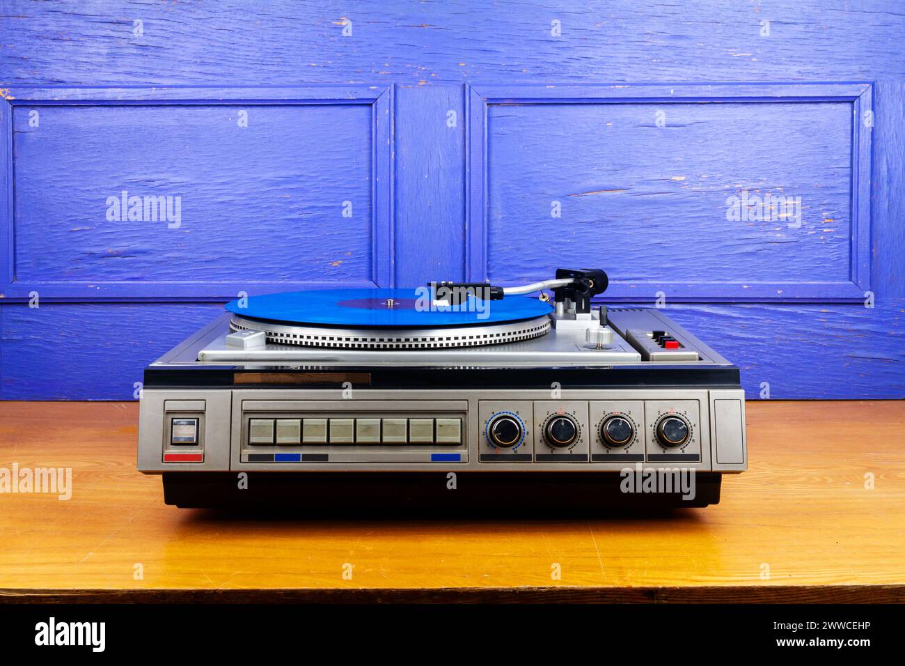 Vintage turntable vinyl record player with blue vinyl on a table Stock ...