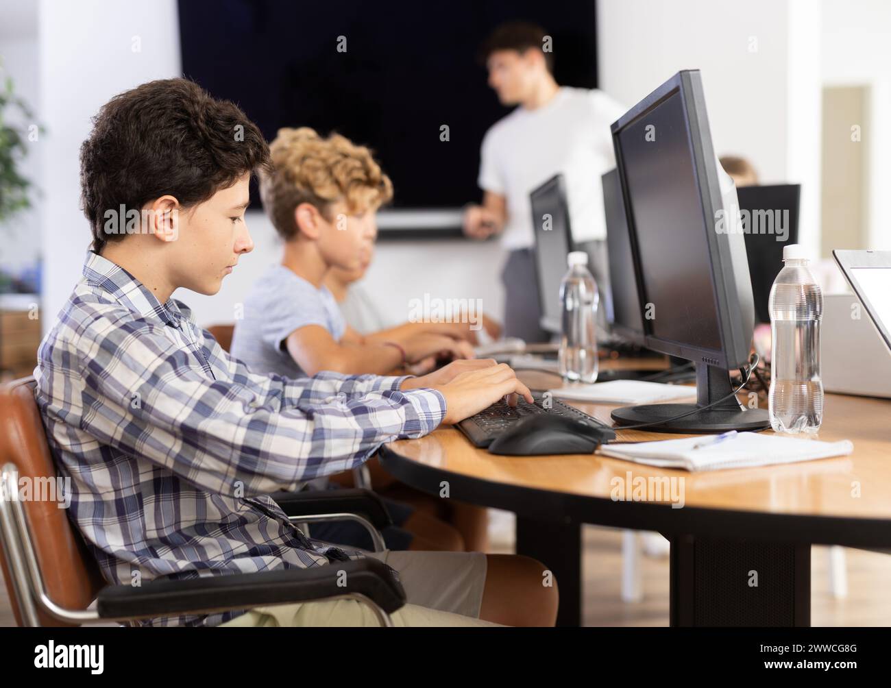 Learning Boy With Computer Boy student learning to work on computer in classroom Stock Photo - Alamy