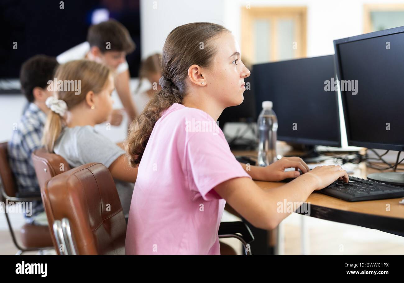 Portrait of female schoolgirl at computers in computer class Stock ...