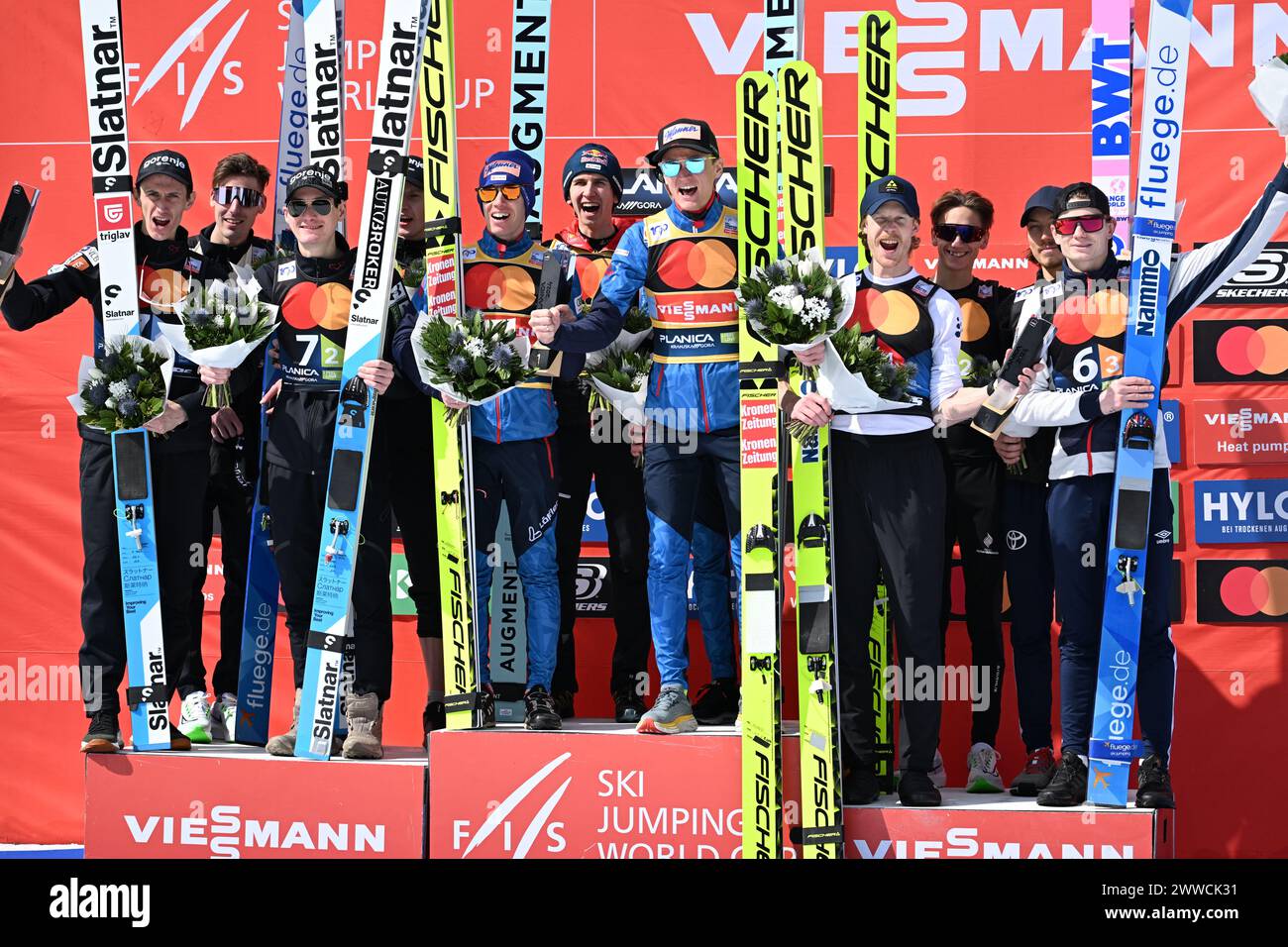 Planica, Slovenia. 23rd Mar, 2024. (L-R) Second Placed team of Slovenia (Lovro Kos, Domen Prevc, Peter Prevc, Timi Zajc), Winner team of Austria (Daniel Tschofenig, Michael Hayboeck, Stefan Kraft, Daniel Huber) and Third Placed team of Norway (Robert Johansson, Benjamin Oestvold, Marius Lindvik, Johann Andre Forfang) celebrates during the Men's Ski Flying Hill HS240 Team of the FIS Ski Jumping World Cup Final. Credit: SOPA Images Limited/Alamy Live News Stock Photo