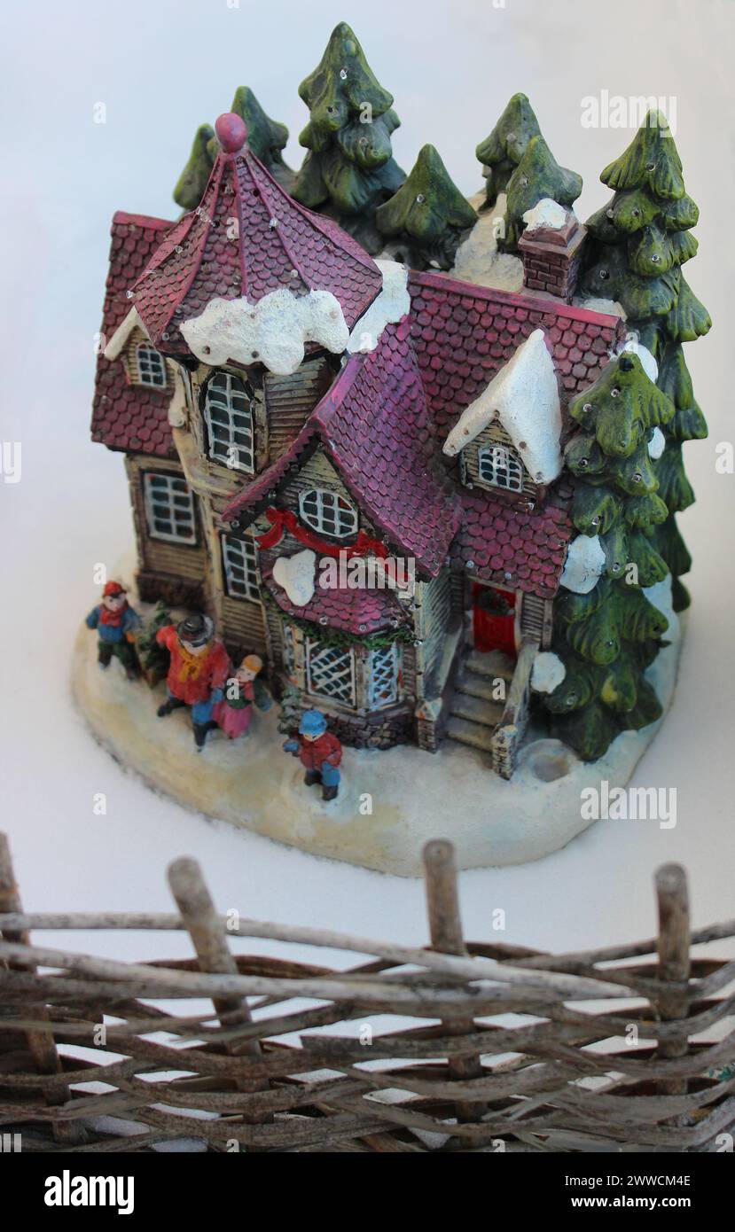 Toy house on the snow behind a wicker fence diorama for children Stock ...