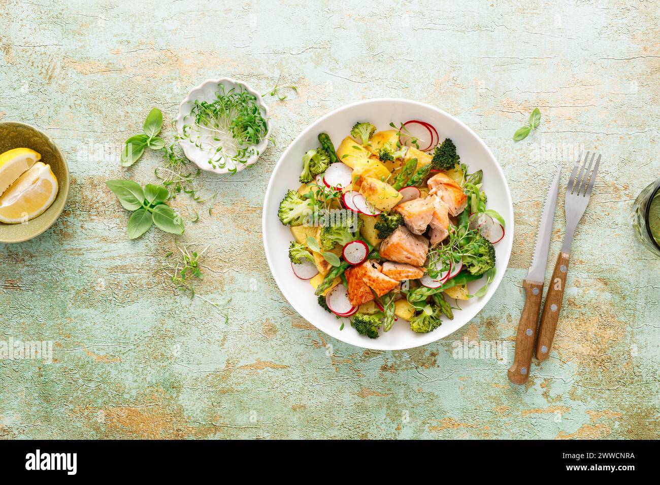 Salmon and potato salad with asparagus, broccoli and radish, top view Stock Photo