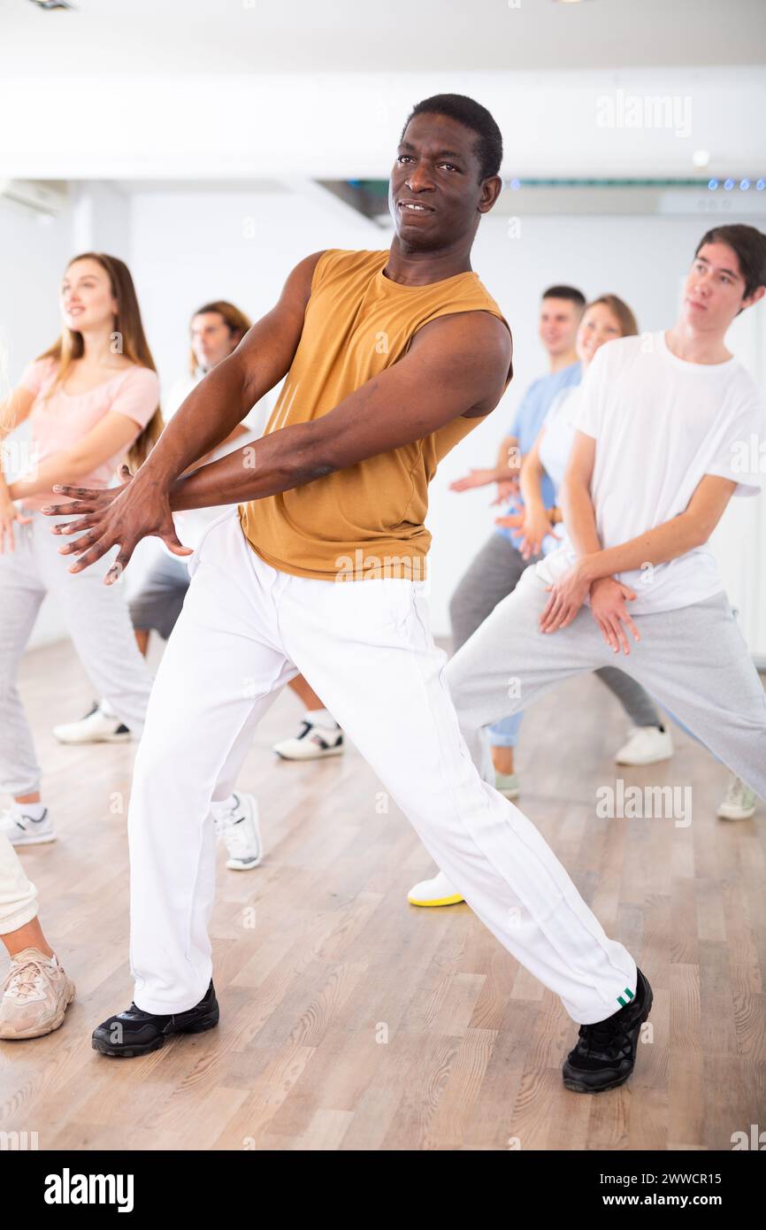 Group of different people rehearsing dance in dance studio Stock Photo Alamy