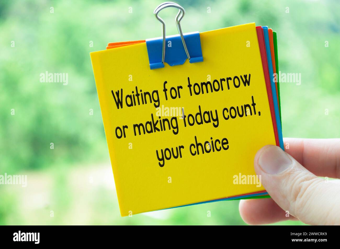 Choice about tomorrow text on sticky notes with bright nature background. Stock Photo