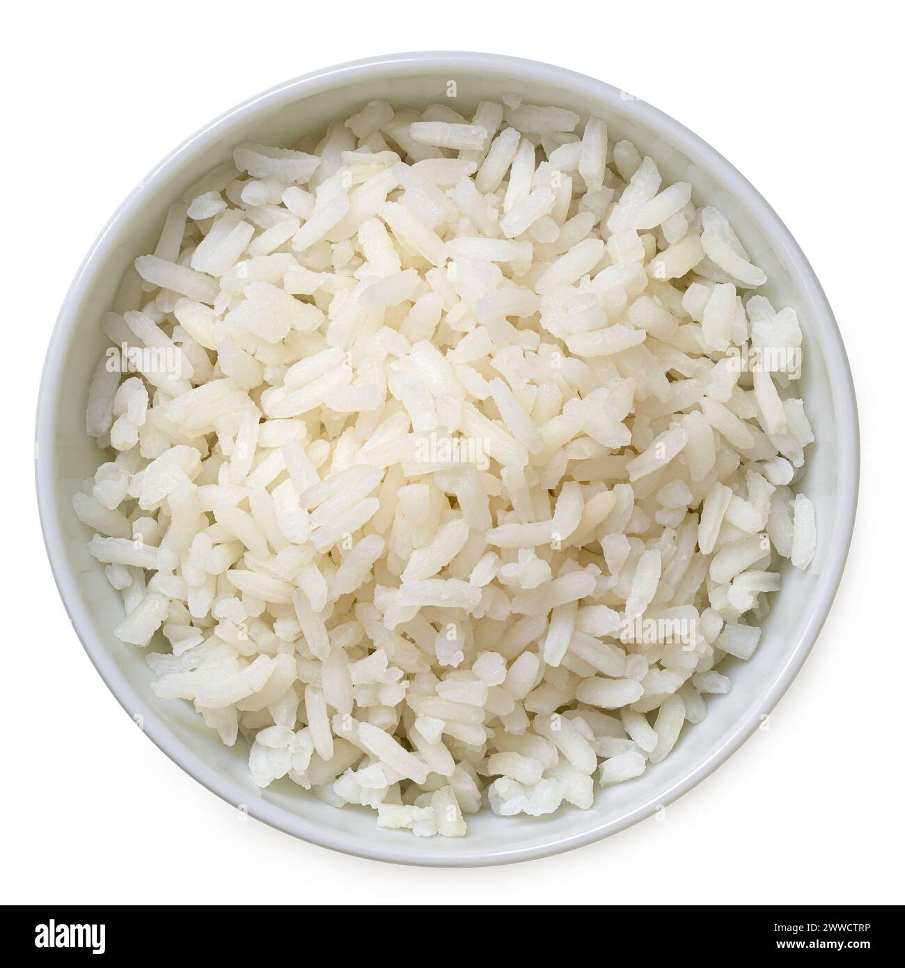 Cooked white rice in a white ceramic bowl isolated on white. Top view. Stock Photo