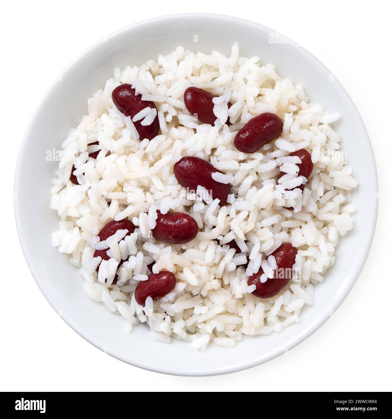 Cooked white rice with red kidney beans in a white ceramic bowl isolated on white. Top view. Stock Photo