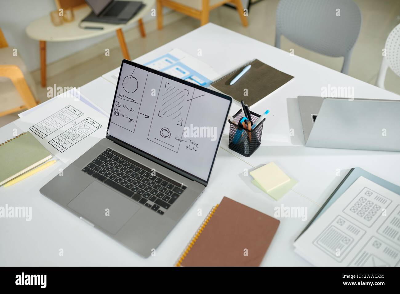 Laptop with mobile application wireframe on screen Stock Photo