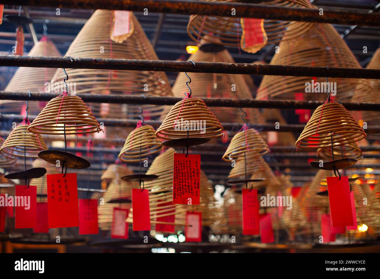 Incense coils of varying sizes hang from the ceiling in Man Mo Temple. Stock Photo