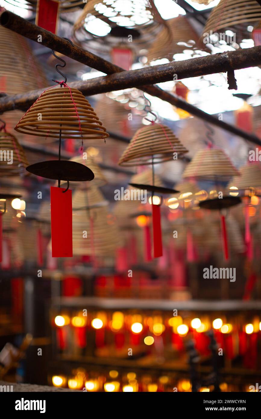 Incense coils of varying sizes hang from the ceiling in Man Mo Temple. Stock Photo