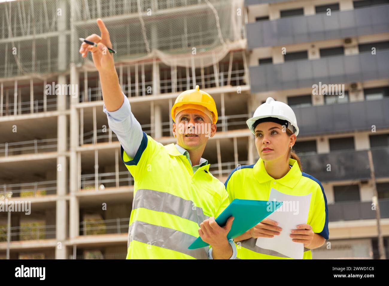 Two qualified engineers are discussing a construction plan Stock Photo
