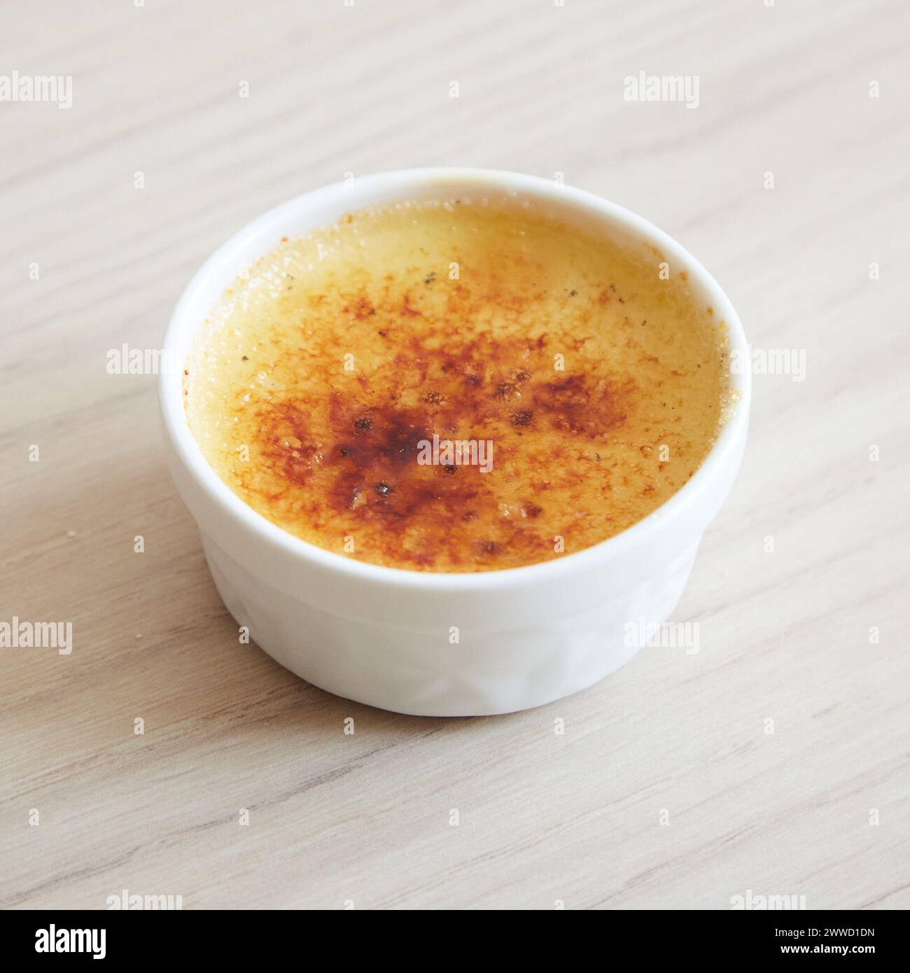 Close Up of Creme Brulee in White Ramekin Stock Photo