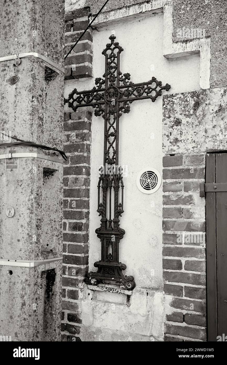 Decorative, Iron Crucifix on an Exterior Wall Stock Photo