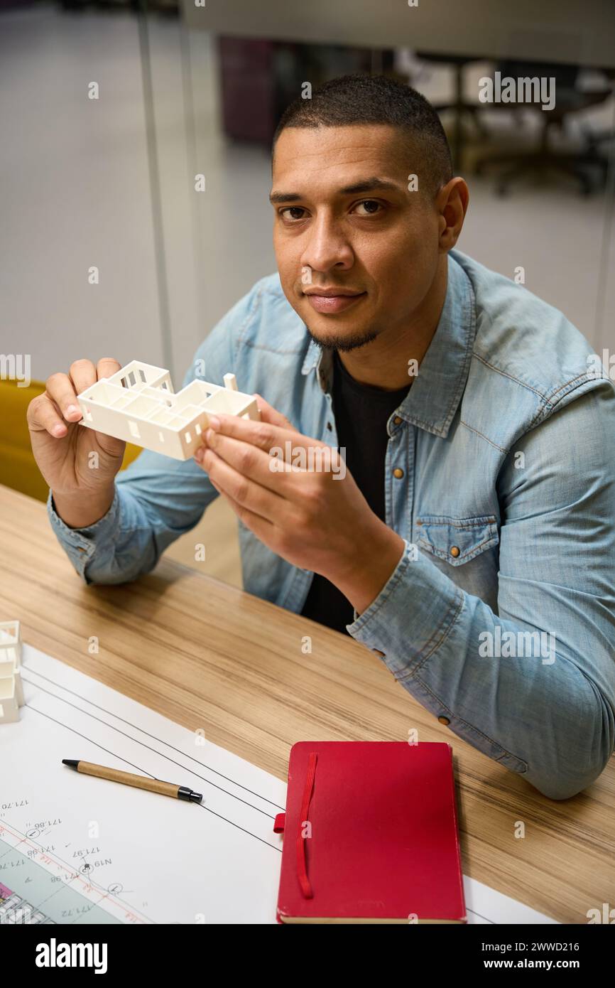 Cheerful guy holding model hi-res stock photography and images - Alamy
