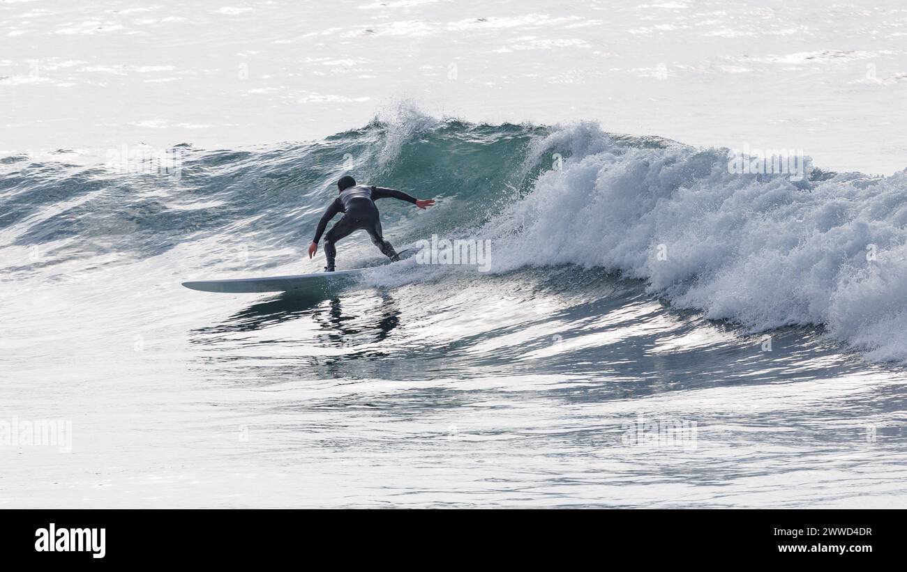A male surfer riding a wave at Polzeath in Cornwall Stock Photo - Alamy