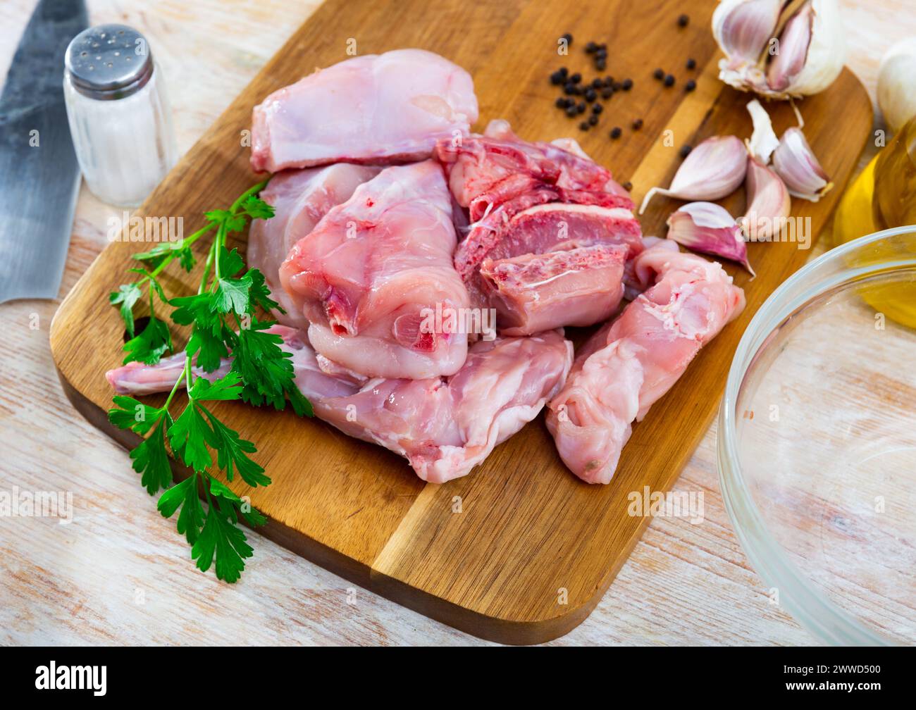 Portioned rabbit legs and saddle with herbs and spices Stock Photo