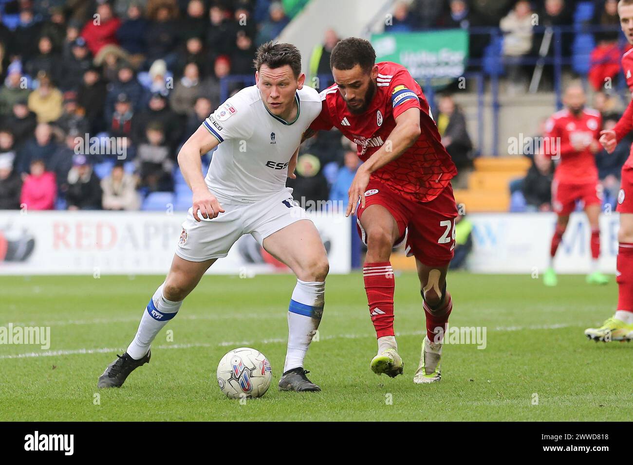 Birkenhead, UK. 23rd Mar, 2024. Connor Jennings of Tranmere Rovers (l) and Jay Williams of Crawley Town battle for the ball. EFL Skybet Football league two match, Tranmere Rovers v Crawley Town at Prenton Park, Birkenhead, Wirral on Saturday 23rd March 2024. this image may only be used for Editorial purposes. Editorial use only, .pic by Chris Stading/ Credit: Andrew Orchard sports photography/Alamy Live News Stock Photo