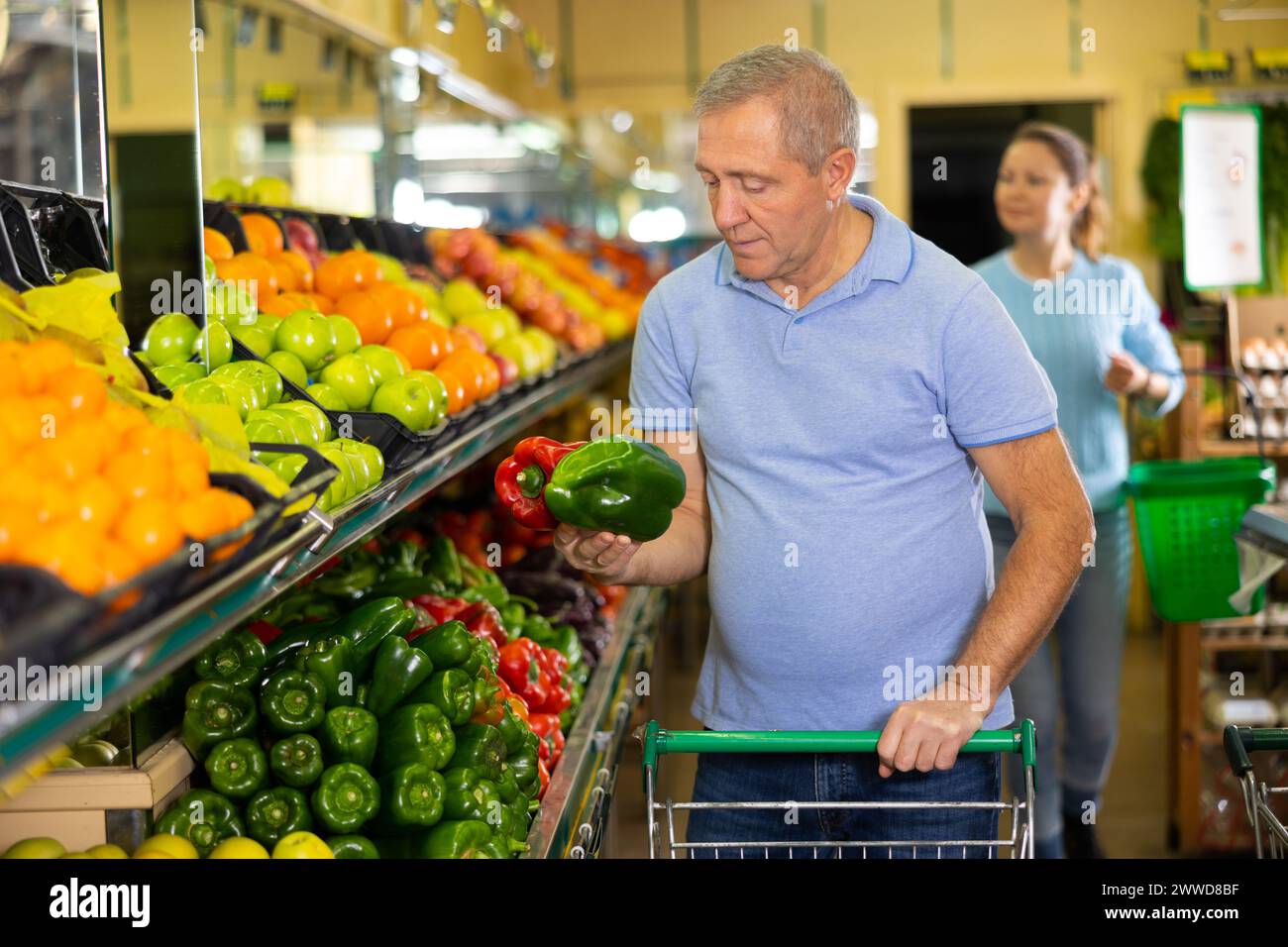 man buy large pepper in supermarket Stock Photo Alamy