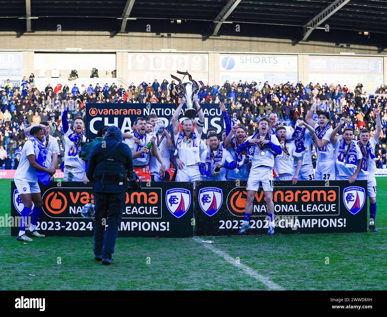 Jamie Grimes of Chesterfield lifts the National League Trophy with his team during the