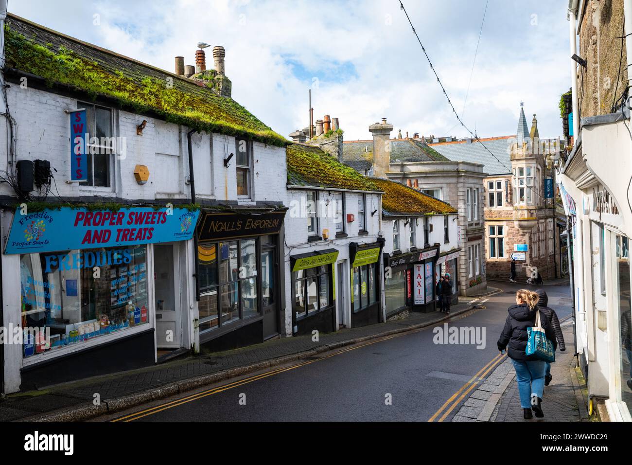 St Ives, Cornwall, 23rd March 2024, People were out enjoying the glorious spring sunshine between the rain showers in St Ives, Cornwall. The temperature was a chilly 9C but with strong winds it felt much cooler. The forecast is for light cloud and moderate breeze for tomorrow. Credit: Keith Larby/Alamy Live News Stock Photo