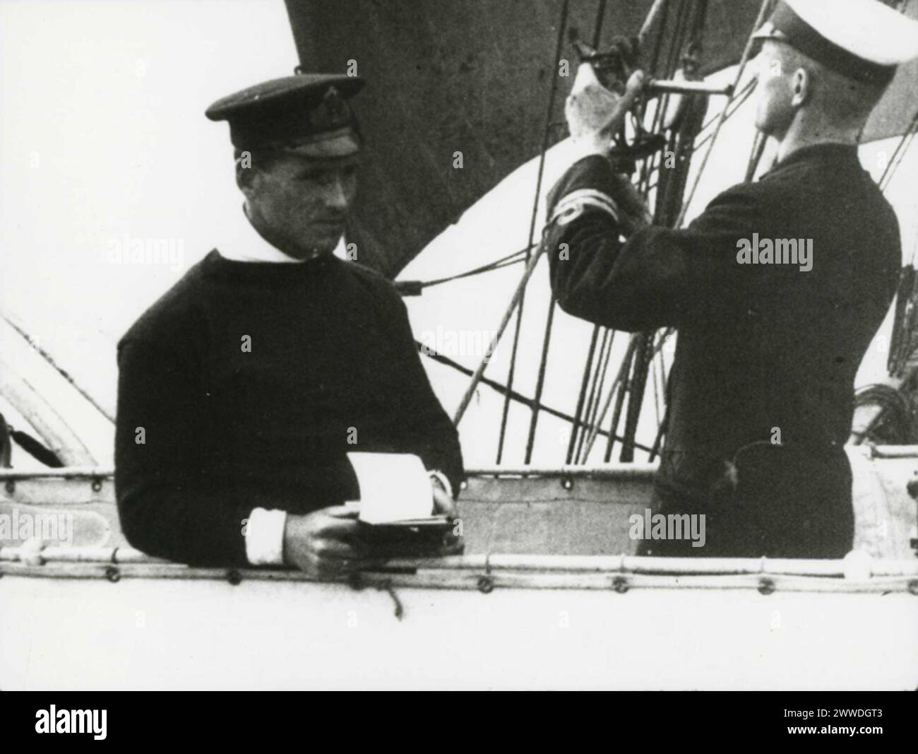 Photograph of an officer studying a scientific instrument while a ...