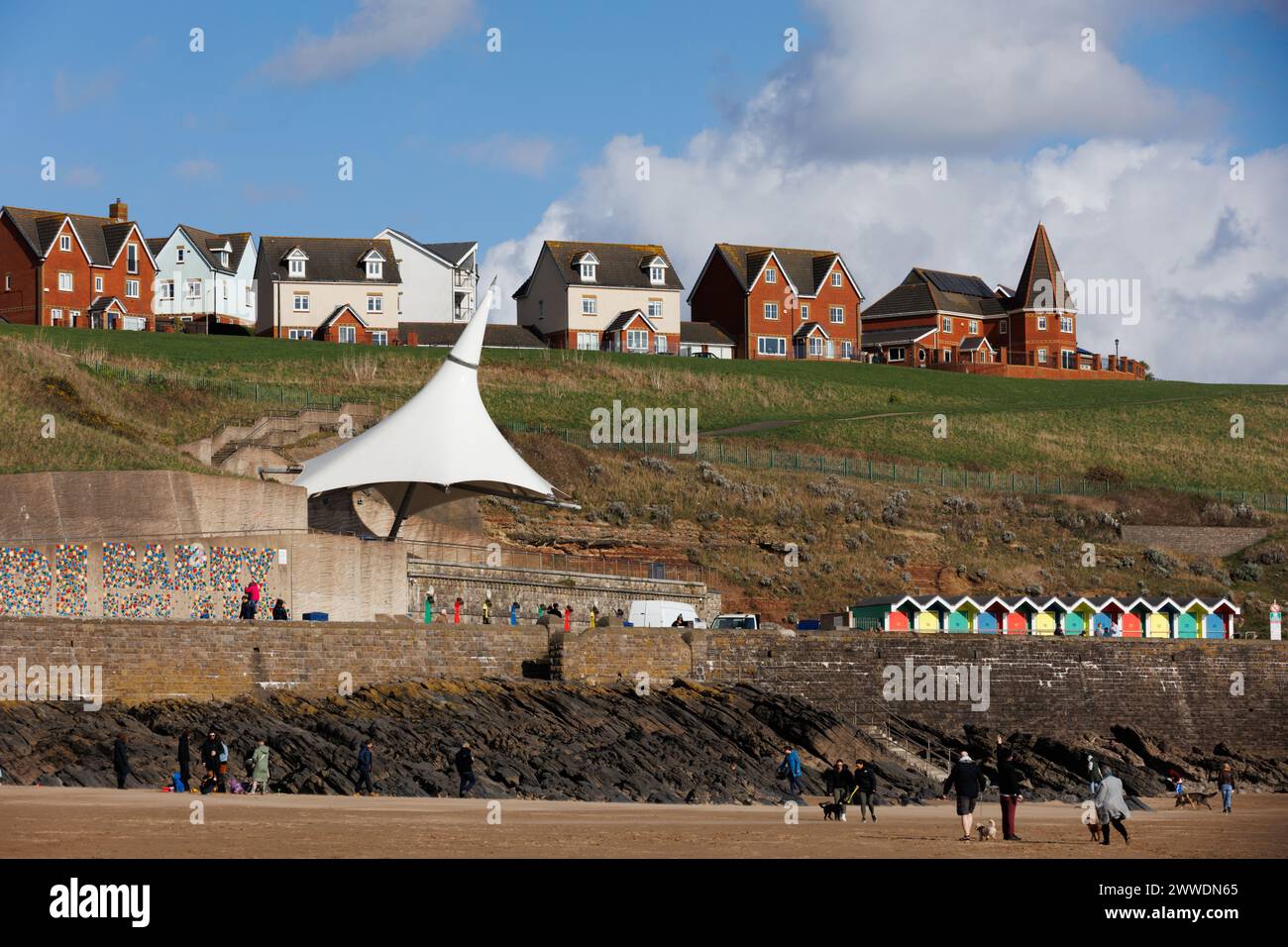 Barry Island, South Wales, UK. 23 March 2024.  People walk along the coast this afternoon.  Credit: Andrew Bartlett/Alamy Live News Stock Photo