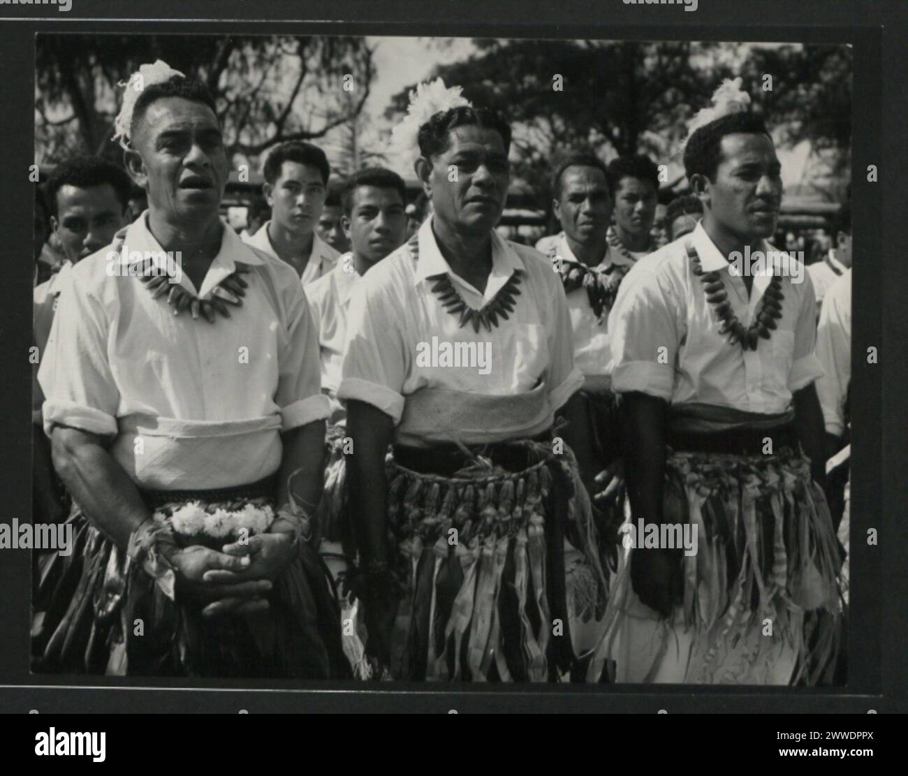 Description: Tongan men waiting to perform during the dancing on the Mala'e Pangai - a public park near the royal Palace. The skirts are known as sisi's and the neklets are made from the fruit of the pandanus. Location: Tonga tonga, australasia, oceania, australasiathroughalens Stock Photo