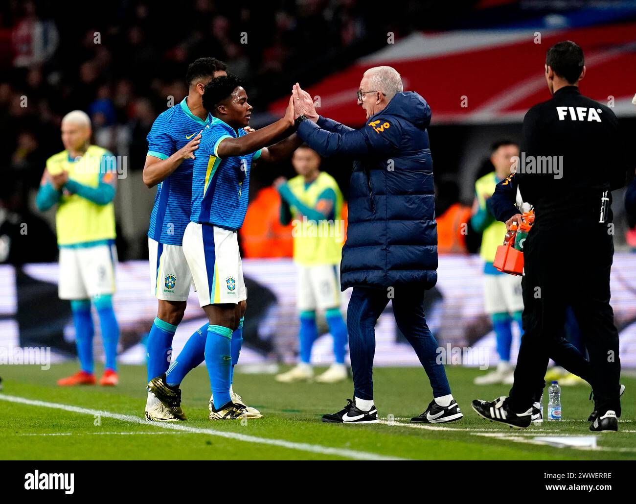 Brazil's Endrick celebrates with manager Dorival Junior after scoring their side's first goal of the game during a international friendly match at Wembley Stadium, London. Picture date: Saturday March 23, 2024. Stock Photo