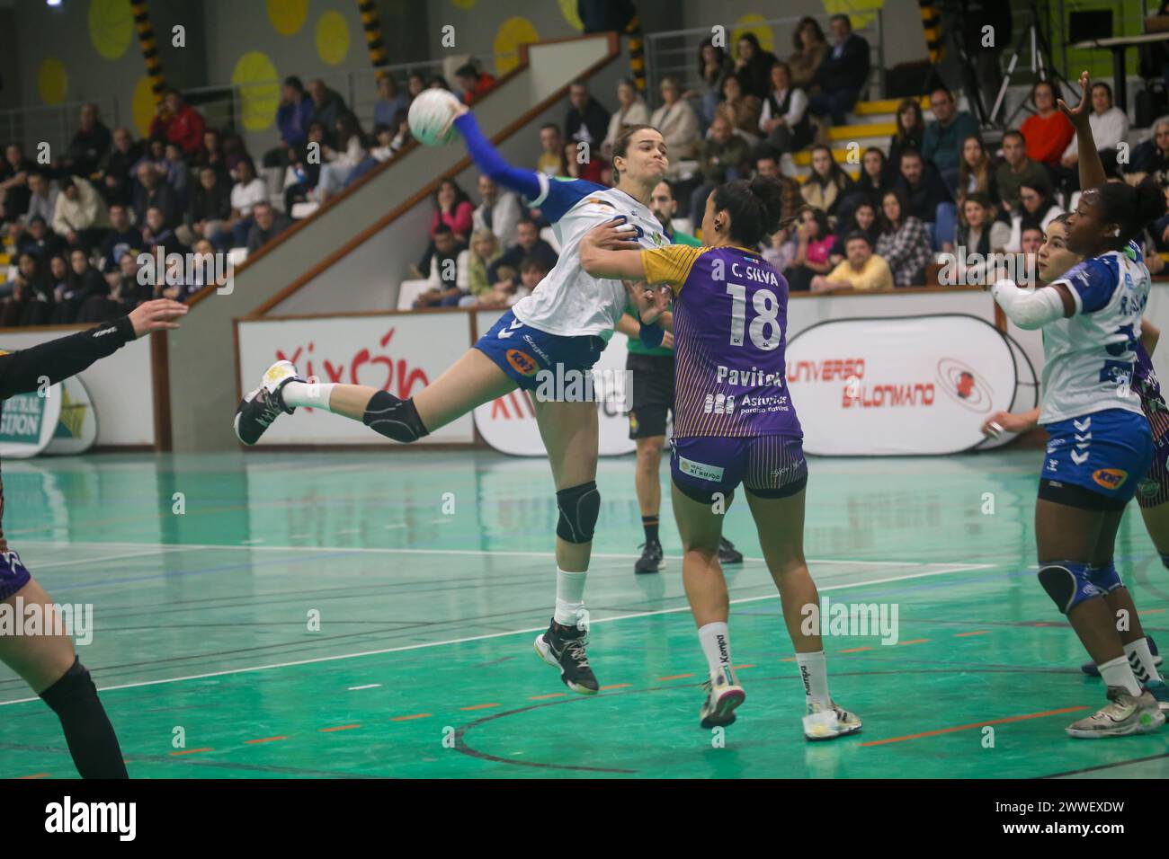 Gijón, Spain, March 23, 2024: The KH-7 BM. Granollers player, Martina Capdevila (99, L) shoots at goal against the defense of Ana Carolina Policarpo (18, R) during the 22nd Matchday of the Iberdrola Guerreras League 2023-24 between Motive.co Gijón Balonmano La Calzada and KH-7 BM. Granollers, on March 23, 2024, at the La Arena Pavilion, in Gijón, Spain. Credit: Alberto Brevers / Alamy Live News. Stock Photo