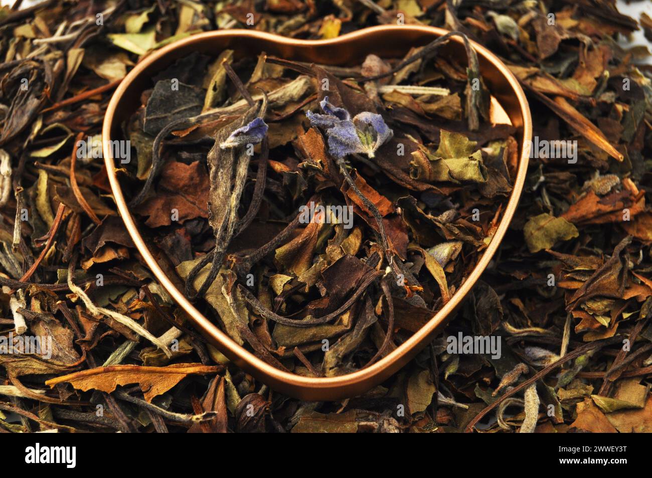 Heart with handmade lavender and lemon balm tea leaves Stock Photo