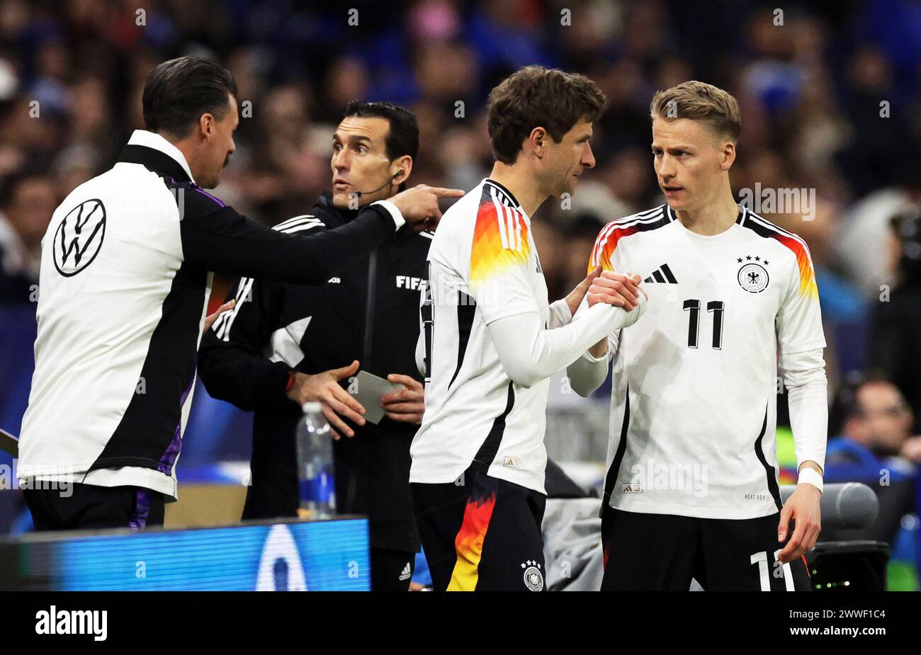 Lyon, France. 23rd Mar, 2024. Soccer: International match, France - Germany, Groupama Stadium. Germany players Chris Führich (r) and Thomas Müller (2nd from right) prepare for their substitution. Credit: Christian Charisius/dpa/Alamy Live News Stock Photo