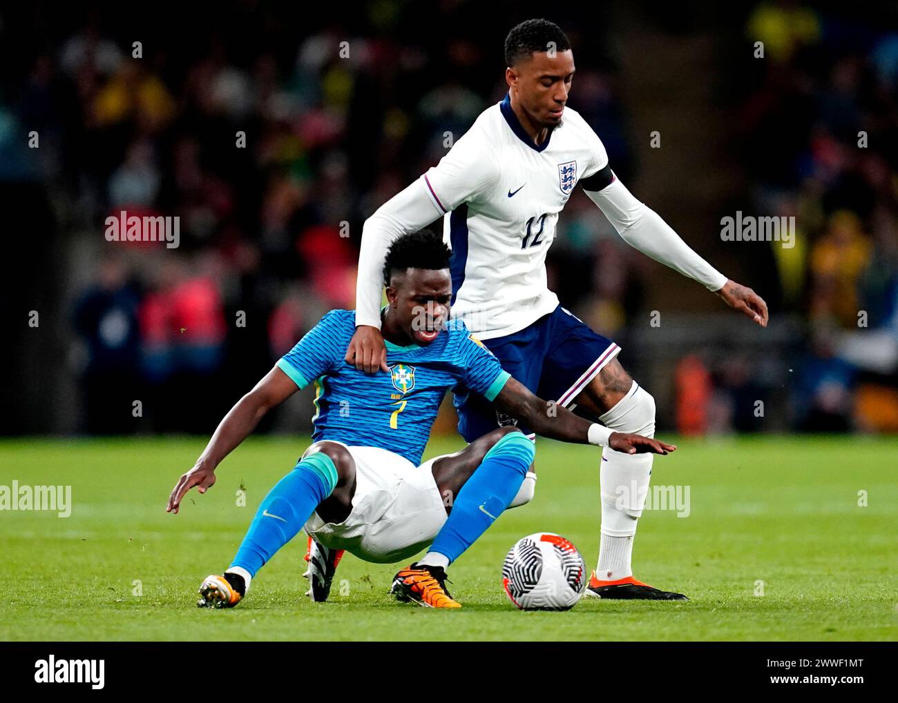 England's Ezri Konsa (right) and Brazil's Vinicius Junior battle for the ball during a international friendly match at Wembley Stadium, London. Picture date: Saturday March 23, 2024. Stock Photo