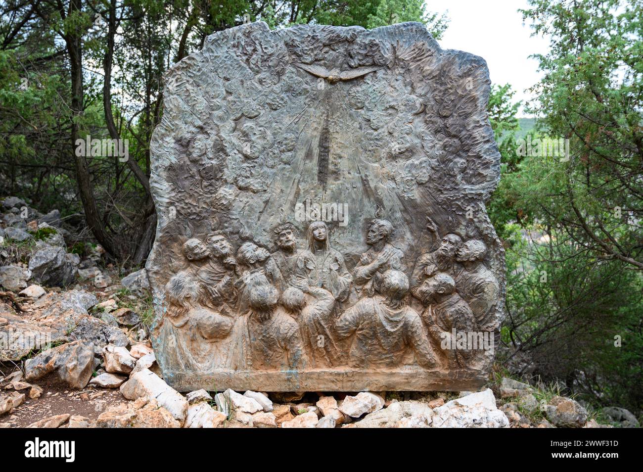 The Descent of the Holy Spirit – Third Glorious Mystery of the Rosary. A relief sculpture on Mount Podbrdo (the Hill of Apparitions) in Medjugorje. Stock Photo