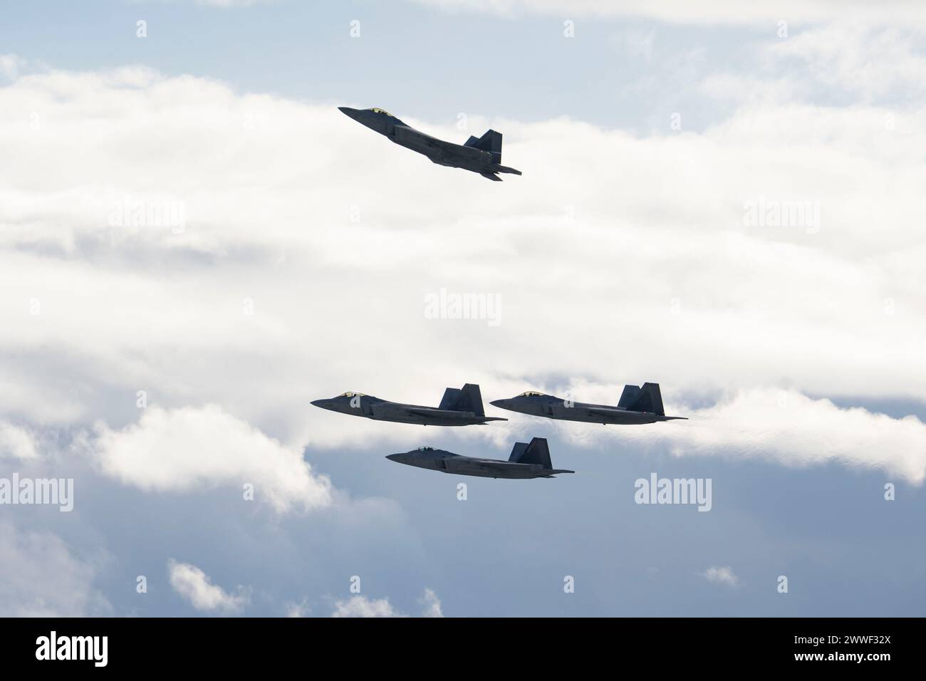 Members of the 3rd Wing and 90th Fighter Generation Squadron conduct a missing man formation flyover in remembrance of Staff Sgt. Charles A. Crumlett at Joint Base Elmendorf-Richardson, Alaska, March 22, 2024. The missing man formation is a military tradition which dates back to World War II and is one of the highest forms of paying respects to fallen service members. (U.S. Air Force photo by Senior Airman Julia Lebens) Stock Photo