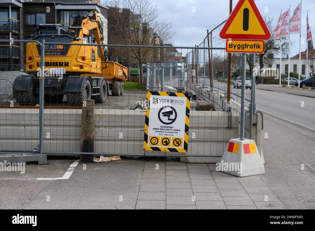 Constructions workplace with excavator, fence and warning signs Stock Photo