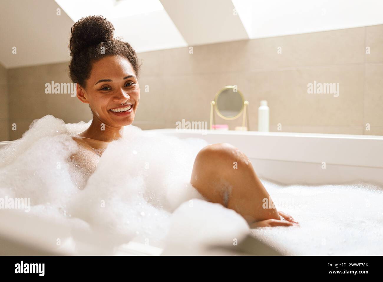 Woman smiles in bathtub hi-res stock photography and images - Alamy