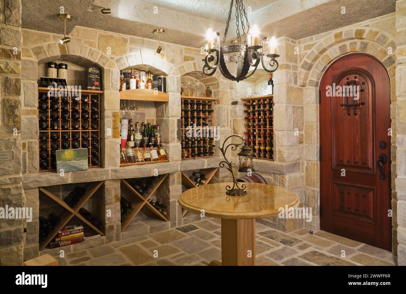 Medieval style beige and tan cut stone wine cellar in basement inside