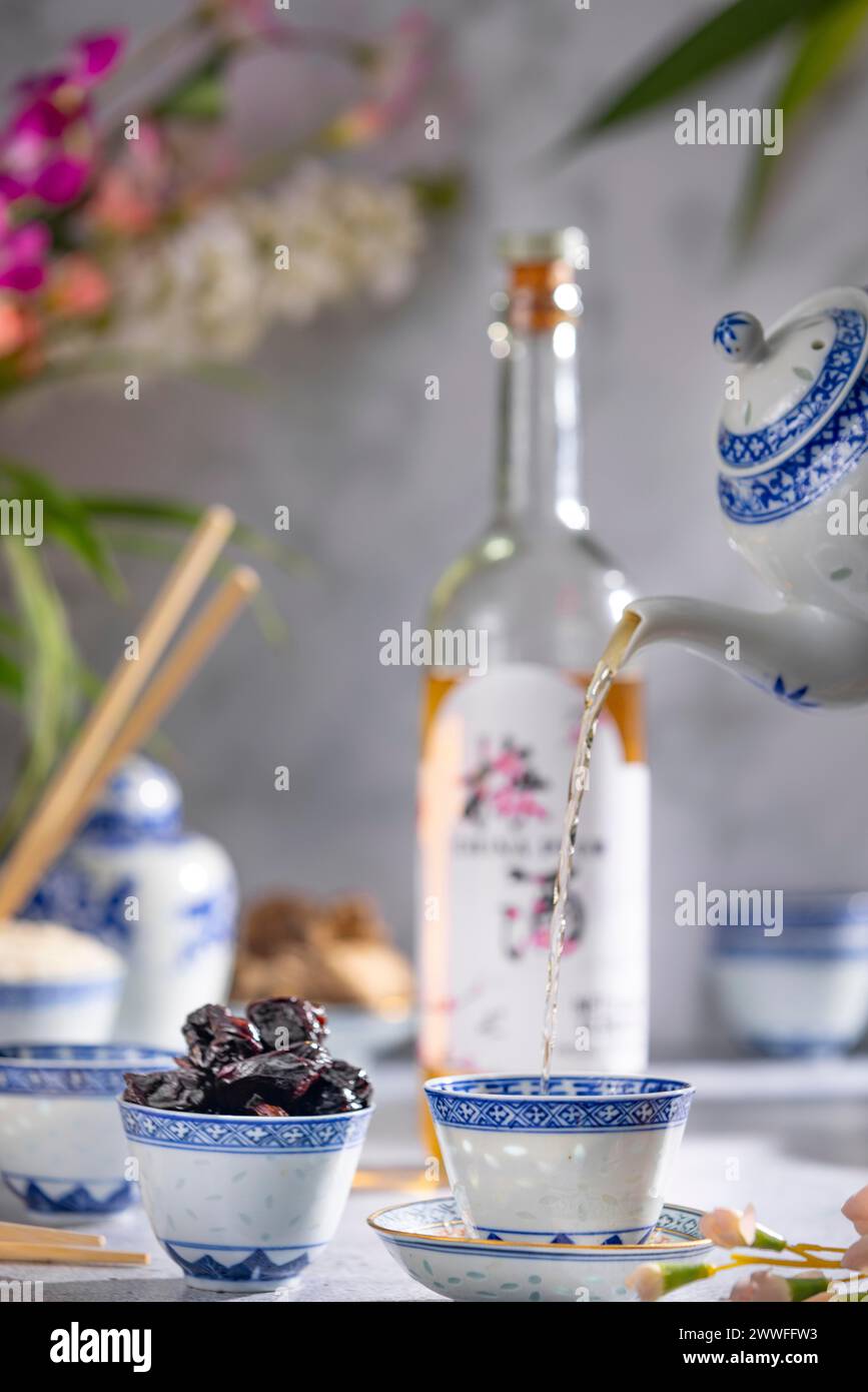 Pouring Tea Pattern Pouring tea, Asian tea set with blue patterns, a bottle of China plum ...