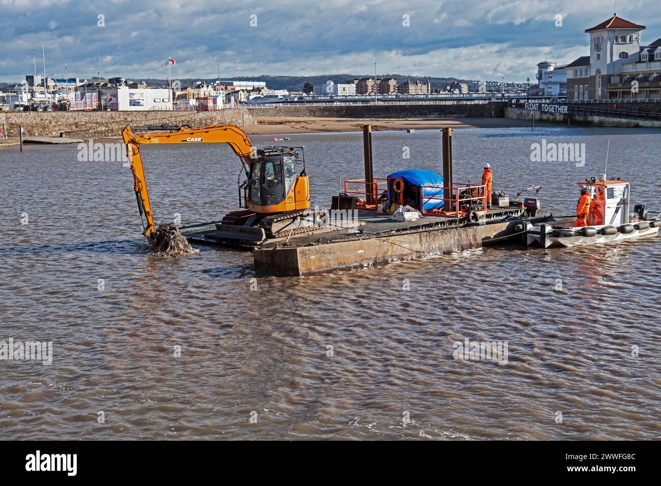 Dredging to remove excess mud from the Marine Lake in Weston-super-Mare, UK on 26 February 2024. Weston-super-Mare is situated on the Bristol Channel, which has one of the highest tidal ranges in the world, and regular dredging is required to ensure that the Marine Lake remains usable for swimming. Stock Photo