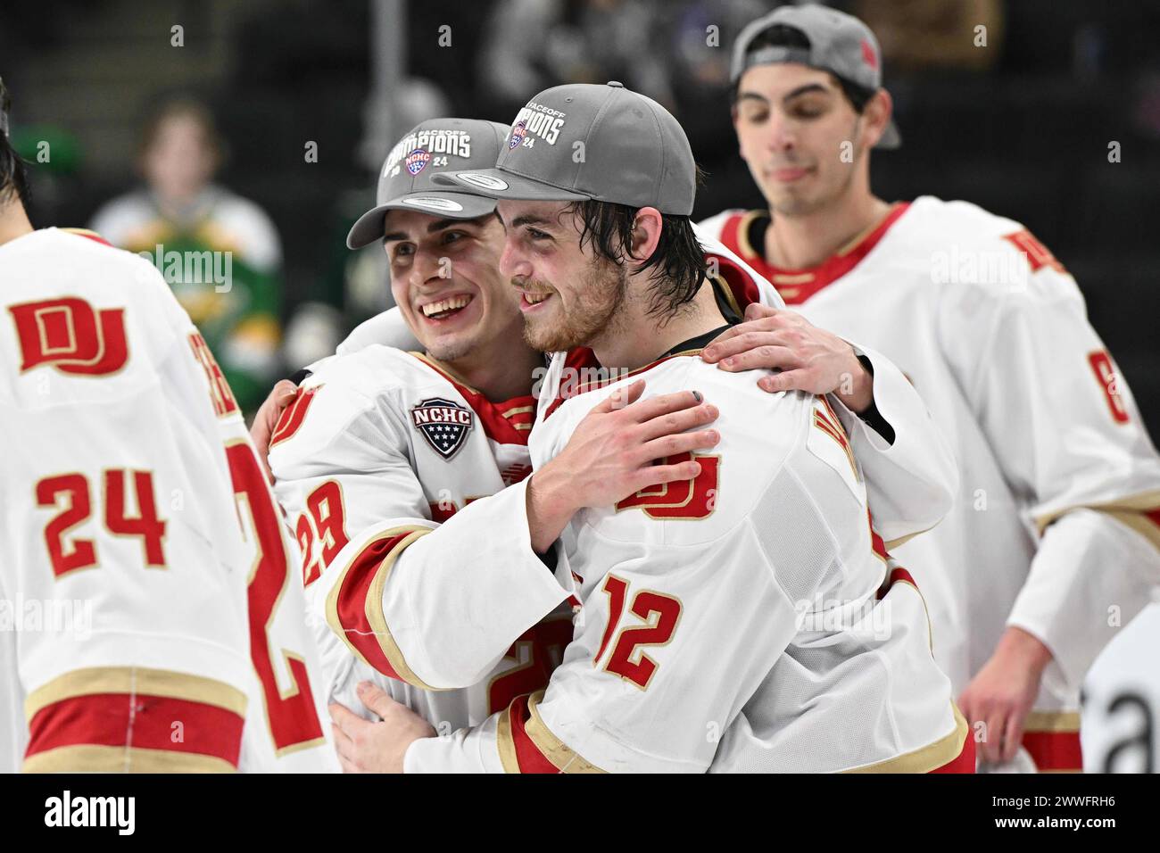 Denver Pioneers forward Sam Harris (12) and Denver Pioneers forward Tristan Lemyre (29) hug after winning the championship game of the NCHC Frozen Faceoff between the University of Nebraska - Omaha Mavericks and the Denver University Pioneers at the Xcel Energy Center, St. Paul, MN on Saturday, March 23, 2024. Denver won 4-1. By Russell Hons/CSM Stock Photo