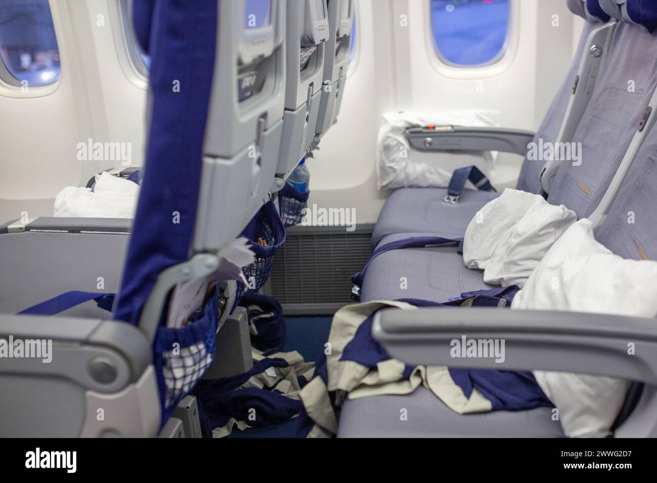 A photograph of an interior of the plane after a long haul flight. Stock Photo