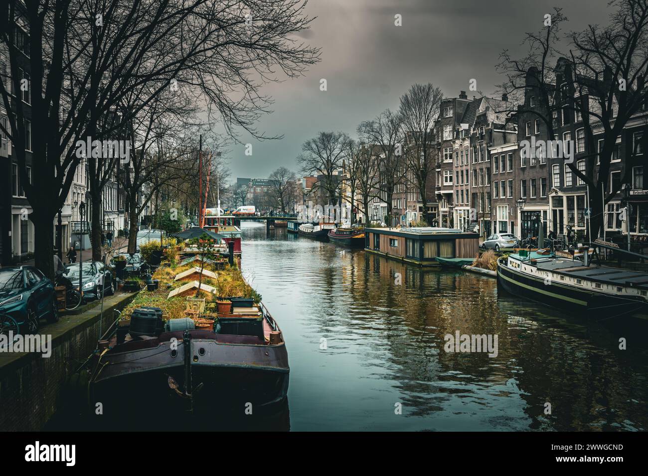 Classic Amsterdam canal houses on a cloudy day, reflecting cultural charm. Stock Photo