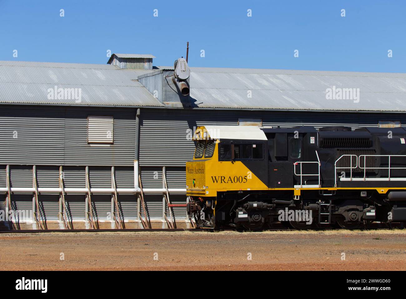Watco Train WRA005 outloading H2 grade wheat from silos at Grain Corp Roma West Depot Roma Queensland Australia Stock Photo