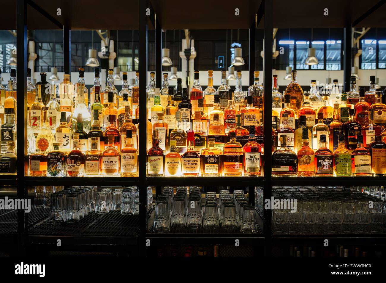 Wide Array of Liquors on Illuminated Shelves at Time Out Market in Lisbon, Portugal. February 2, 2024. Stock Photo