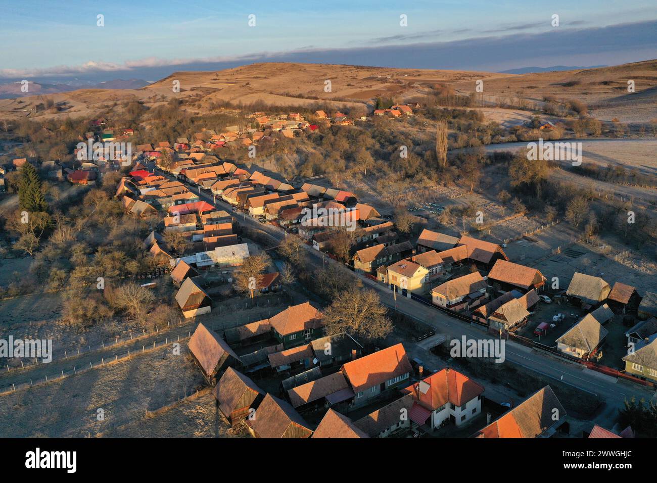 Aerial drone view of residential houses in a village during morning sunrise lights Stock Photo