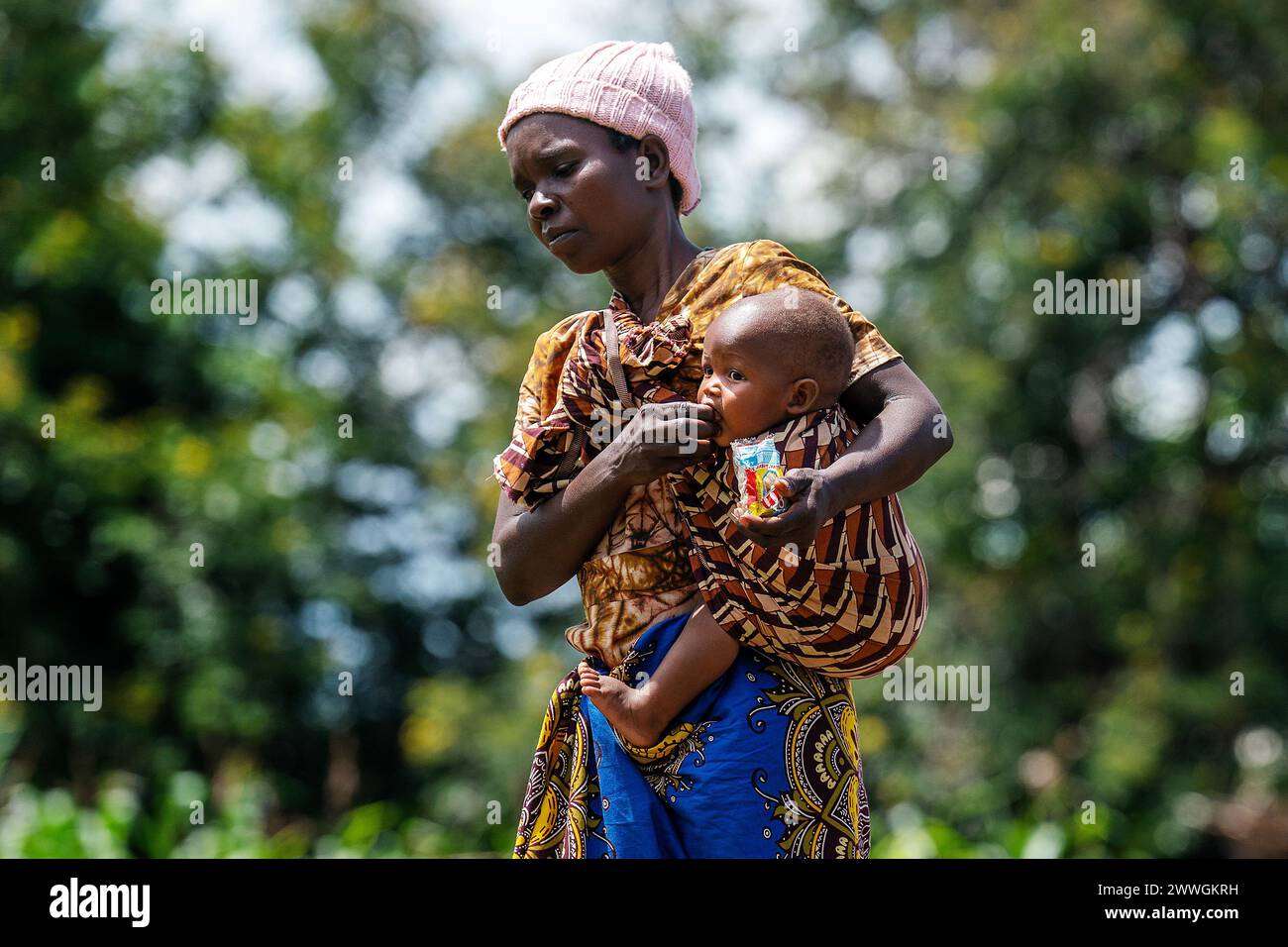 A woman feeds a child in the flooding-prone regions around Lake Chilwa in the Machinga district of Malawi. Villages in these communities have not recovered completely from Cyclone Freddy, and are doing what they can to prepare for next time. Picture date: Tuesday March 5, 2024. Stock Photo